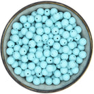 Ronde siliconen kraal van 12 mm in de kleur Zachtturquoise met zwarte spikkels