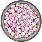 Ronde siliconen kraal van 15mm met een rozenprint in roze en paars
