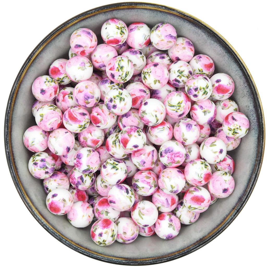 Ronde siliconen kraal van 15mm met een rozenprint in roze en paars